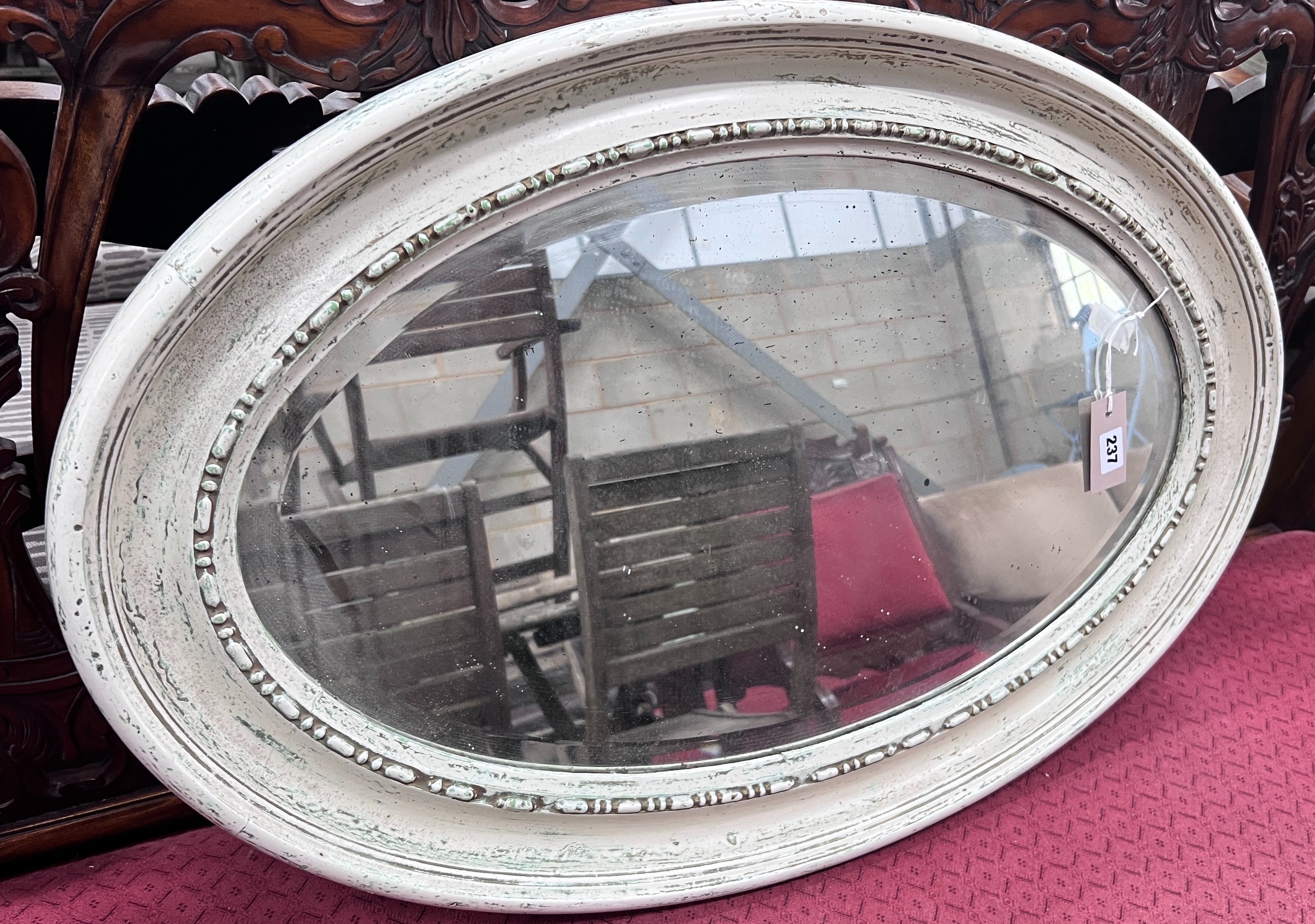 A 1920's white gesso framed oval wall mirror, 84cm *Please note the sale commences at 9am.